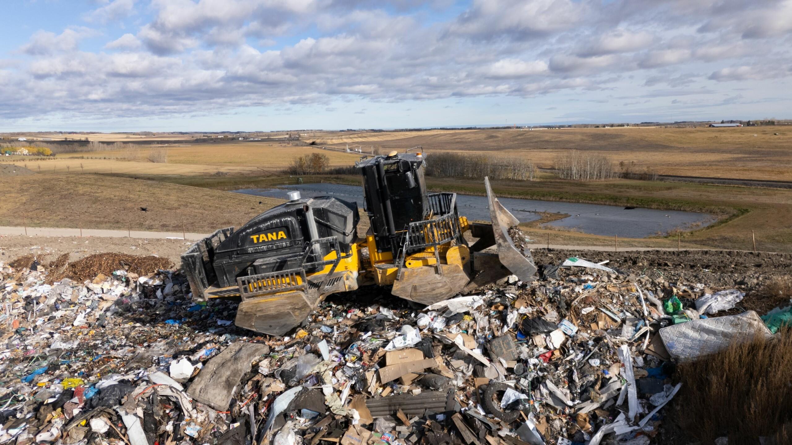 TANA landfill compactor compacting waste in landfill
